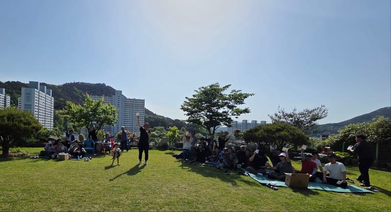 햇살 아래 잔디밭에 모인 성도들